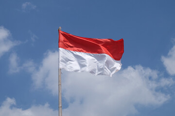 Naklejka na ściany i meble The Indonesian flag flutters on a bamboo pole