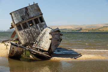 Dilapidated old boat stranded on sandbar 