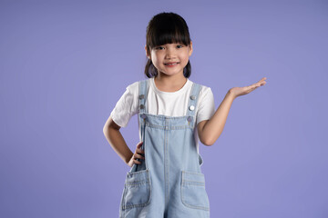 cute asian girl posing on purple background