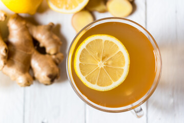 Ginger tea on white table with lemon - Powered by Adobe