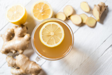 Ginger tea on white table with lemon