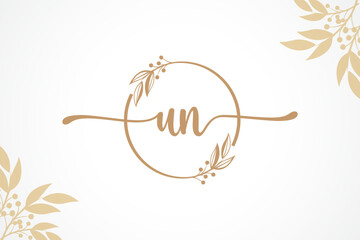 luxury gold signature initial un logo design isolated leaf and flower