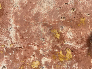 Brown grungy, distressed plaster wall with peeling paint in Mexico. Texture Background.