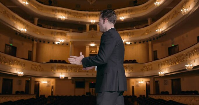 American businessman practicing speech in empty auditorium learning how to Presents New Product Slow motion He Does Motivational Talk Lecture about Science Technology Entrepreneurship Development