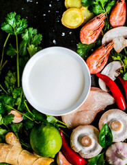 Cooking Tom Yam soup, laid out ingredients, top view, on a dark background..