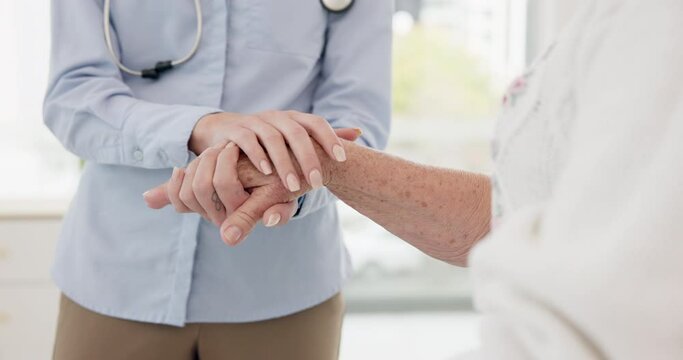 Doctor, holding hands and senior person at hospital for help, trust and healthcare consultation. Empathy, support and nurse with old patient at a clinic for bad news, results or cancer diagnosis