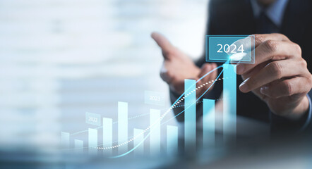 Businessman touching on business growth graph for year 2023 to 2024. new business goals, plans and strategy. Business Development concept - obrazy, fototapety, plakaty