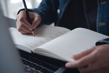 Planner plan schedule calendar and reminder agenda, online work at home. Woman planning daily appointment and write business trip in diary at office desk. 2024 Calendar reminder event planning 