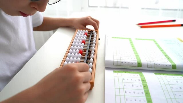 The boy is engaged in abacus, mental arithmetic for children