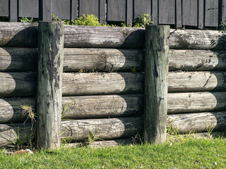 Cantilever wooden half rounds pole retaining wall. For residential sites.