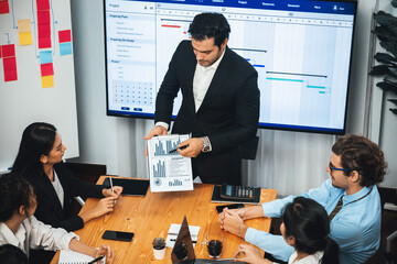 Project manager planning schedules for business task at meeting room, Gantt chart software show on...
