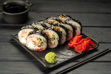 Sushi Roll with salmon, fried tuna, avocado and cheese. Sushi menu. Japanese food concept.