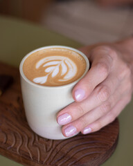 woman hands holding a cup of coffee