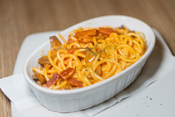 Traditional pasta spaghetti in white plate on wooden table background