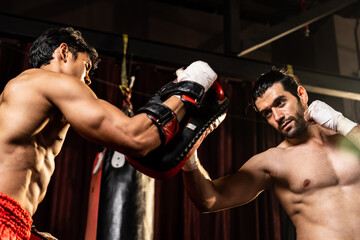 Asian and Caucasian Muay Thai boxer unleash upper cut punch attack in fierce boxing training...