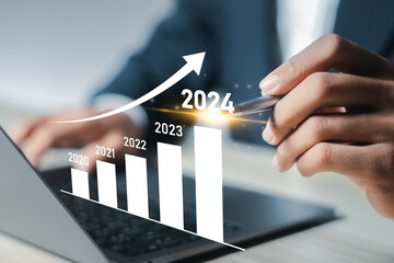 New year business goals 2024 and positive indicators 2024, businessman analyzing economic trend...