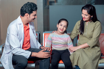 Indian doctor caring and supporting of little girl patients at hospital.