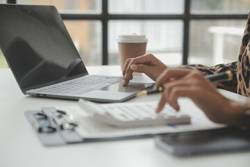 Fototapeta premium Entrepreneur Asian businessman and businesswoman discussing new business project in tablet in modern Meeting In Modern Office, Asian business casual concept.