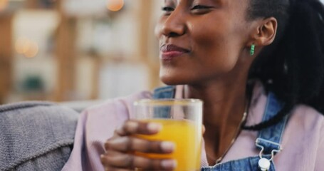 Happy, black woman and orange juice in home living room on sofa in healthy diet, nutrition and wellness. African person, smile and drink fruit glass in hydration, organic vitamin c or vegan benefits - Powered by Adobe
