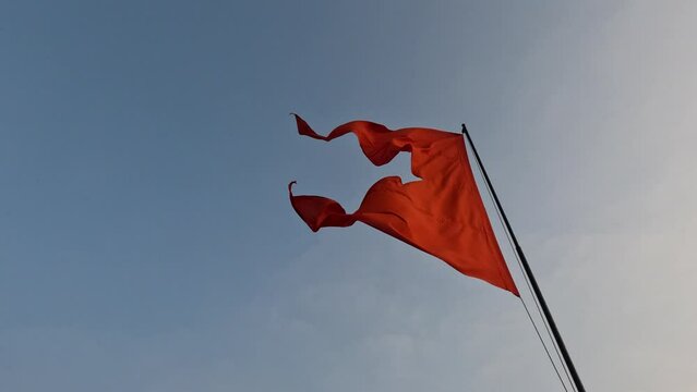 Saffron flag waving or fluttering repersenting Hindu culture