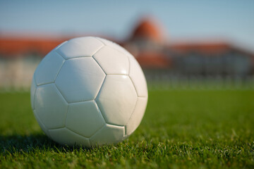Soccer on grass and stadium. Ball on field. White soccer ball for mockup