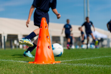 Youth soccer practice drills. Young football player training on pitch