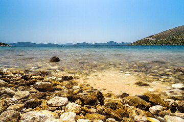 A desolated pebble beach on the Adriatic Sea near the city of Dubrovnik. The water is crystal clear with a turquoise color