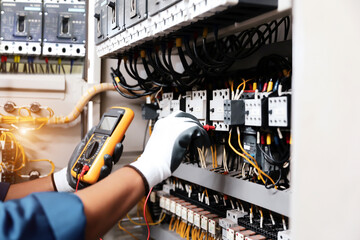 Electricity and electrical maintenance service, Engineer hand checking electric current voltage at...