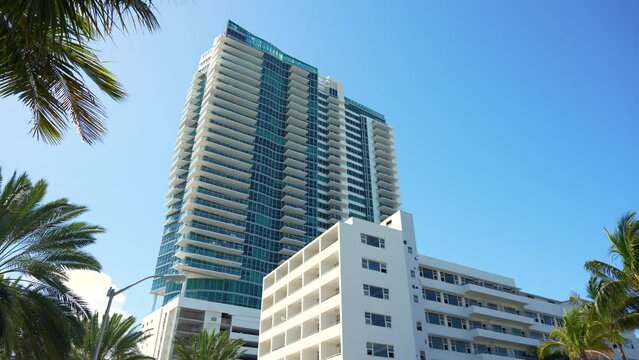 Low angle view of Miami Beach city with expensive highrise hotels and condo buildings on Atlantic ocean shore. American tourism infrastructure in coastal southern Florida