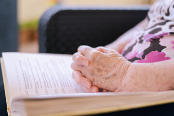 Hands Of An Elderly Woman With Bible