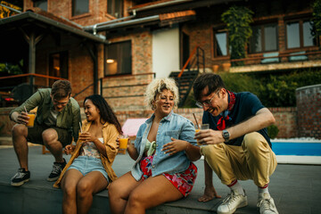 Men approaching to a women, laughing and talking during a house pool party