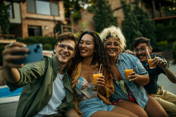 Friends having a selfie during a backyard party.