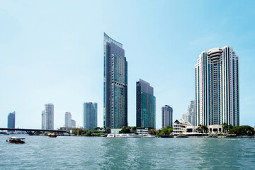 Chao Phraya River in Bangkok with modern buildings in the background.