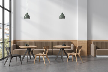 Stylish cafe interior with chairs and sofa, eating area with panoramic window