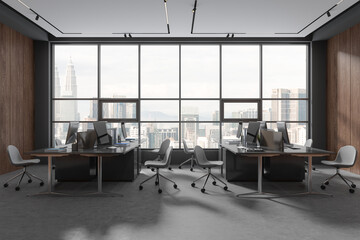 Modern office interior with pc computer on table, armchairs and panoramic window