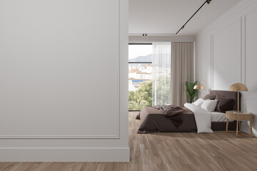 Elegant hotel bedroom interior with bed and panoramic window. Mock up wall