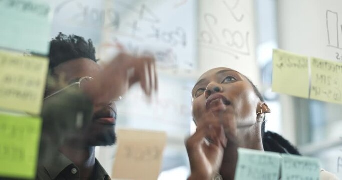 Black people, meeting and planning in schedule brainstorming, strategy or ideas on glass board at office. African man and woman in team project plan, tasks or reminder on sticky note at the workplace