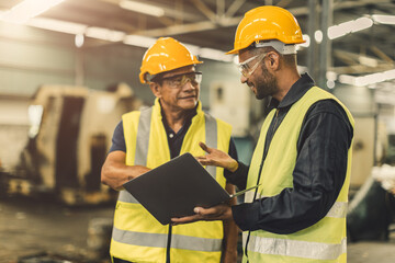 Asian male workers team work meeting talking consulting together in heavy industry factory