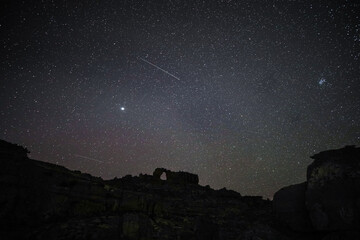 Starry night with meteor flying over Wolfberg Arch in the Cederberg, South Africa