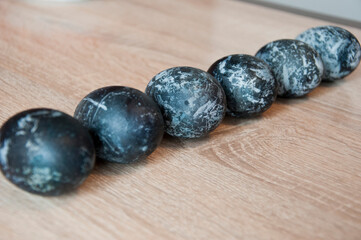 bunny hunt begin. egg hunt. traditional galaxy painted eggs on wood table. minimalistic design. hunting eggs in springtime. spring eastertime holiday. easter egg. happy easter. paschal april holiday