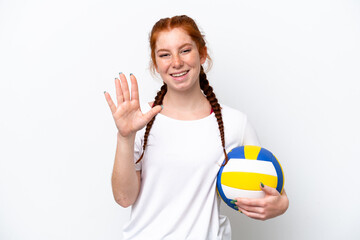 Young caucasian reddish woman playing volleyball isolated on white background saluting with hand with happy expression