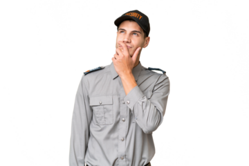 Young security man over isolated background having doubts and with confuse face expression