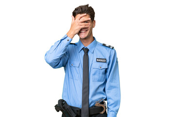 Young police man over isolated background covering eyes by hands and smiling