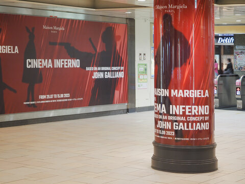 TOKYO, JAPAN - August 11, 2023: A pillar and wall in Omotesando subway station with adverts for  Maison Margiela's Cinema Inferno by John Galliano. 