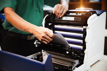 Technician hand open cover photocopier or photocopy to fix repair copier paper jam and replace ink...