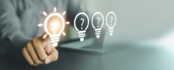 Close up hand choose light bulb or lamp with bright for human resources or leadership and creativity thinking idea motivation or vision and knowledge learning. © Jintana
