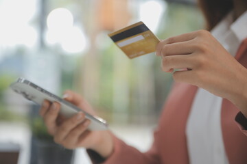 .Women holding credit card and using smartphones at home.Online shopping, internet banking, store...