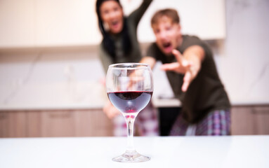 Happy young couple in love hugging holding glasses, drinking wine, celebrating Valentines day
