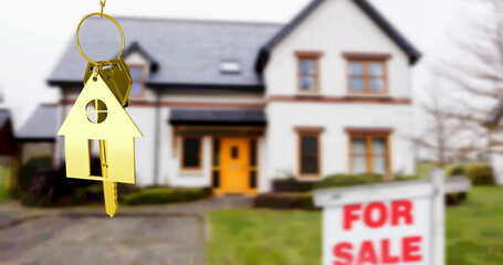 Image of gold house key fob and key, hanging in front of blurred house with for sale sign