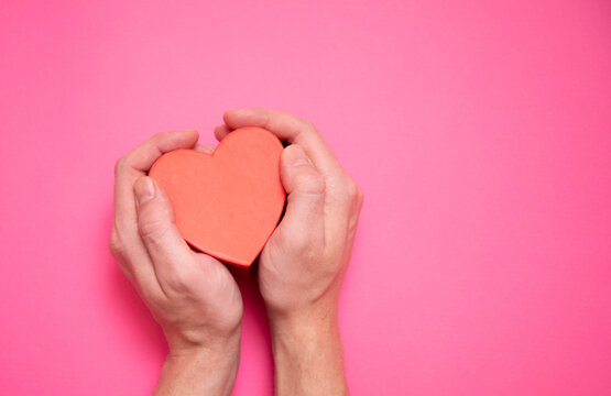 Giving a heart, hand gives a valentine. Concept of valentine's day, declaration of love